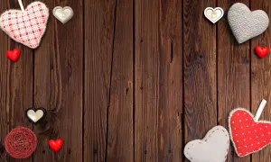 Valentine's Day Hearts and Candles on Wooden Background