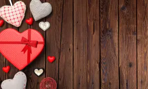 Heart-Shaped Valentine's Day Gifts and Decorations on Wooden Background