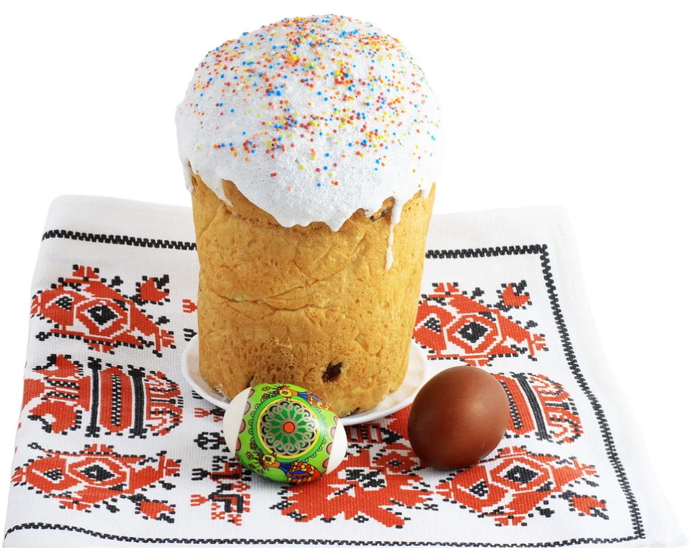 Easter Kulich Cake with Decorated and Brown Easter Eggs on Embroidered Cloth