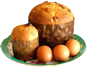 Two Panettone Cakes with Three Brown Eggs on Decorative Plate